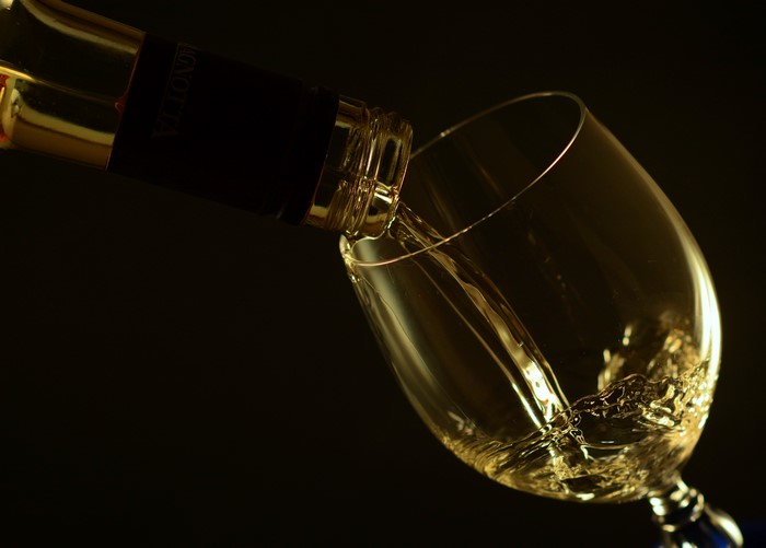 White wine being poured into a glass