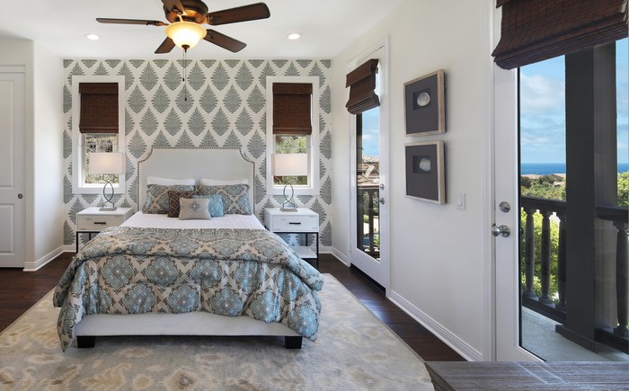 Bedroom with patterned wallpaper and ocean view