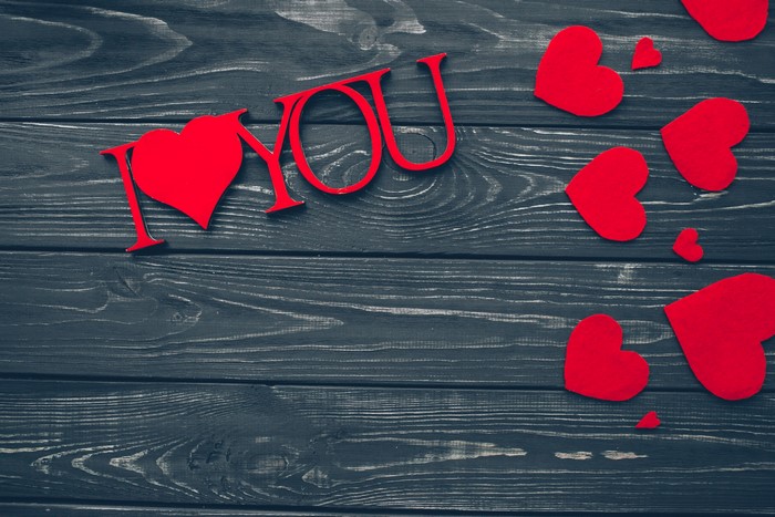 I Love You text with red hearts on wood planks