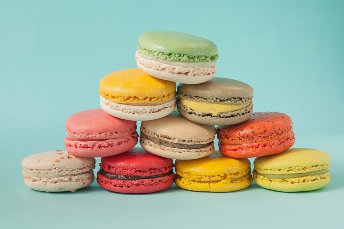 Stack of colorful macarons on a blue background