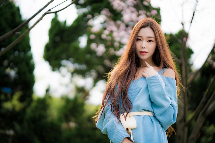 Asian woman with brown hair in blue dress
