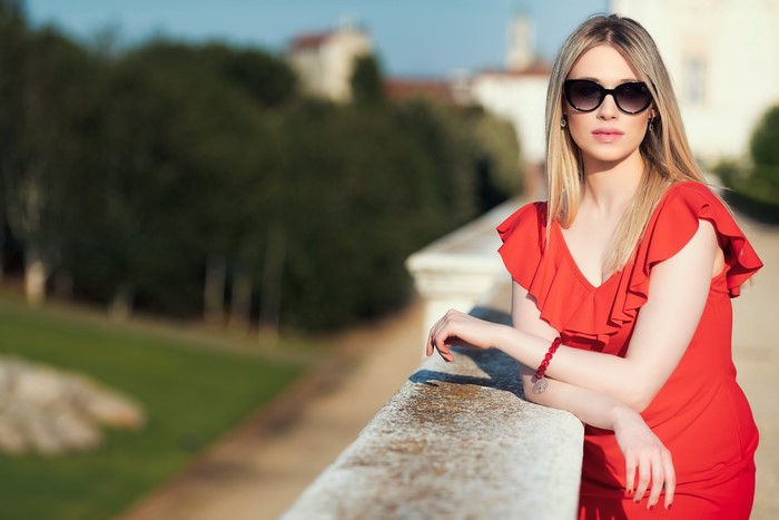 Chiara wearing a red dress and sunglasses