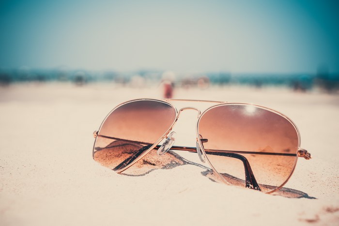 Aviator sunglasses on a sandy beach