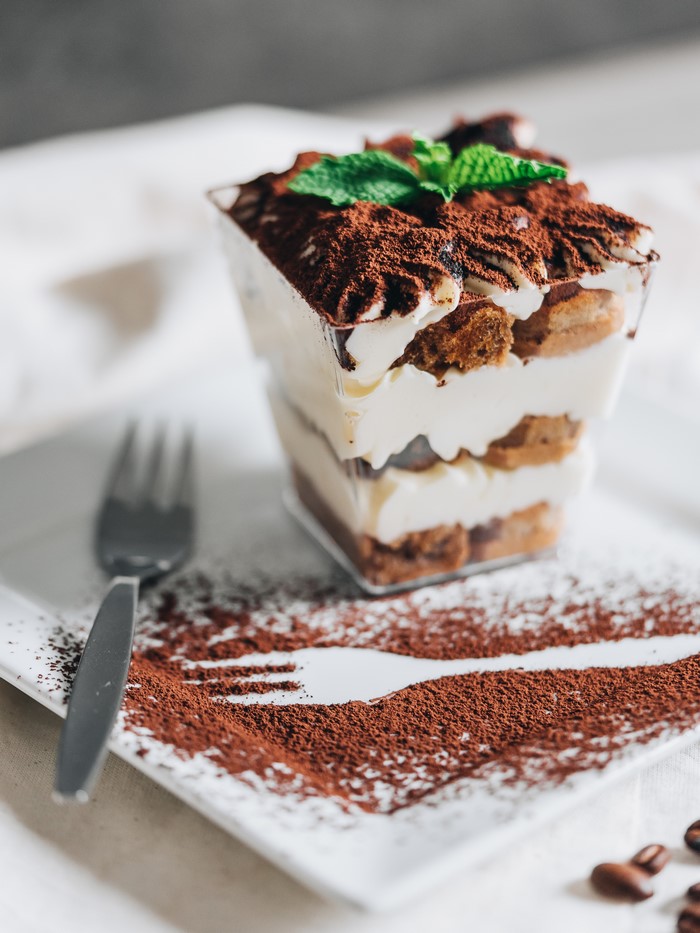 Tiramisu dessert with cocoa powder and mint