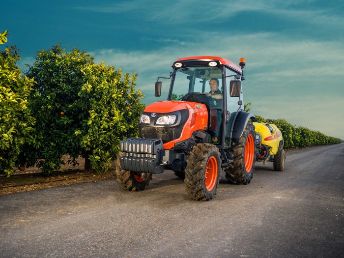Kubota M5101N Cab tractor with sprayer in orchard