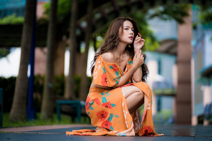 Asian woman in orange floral dress