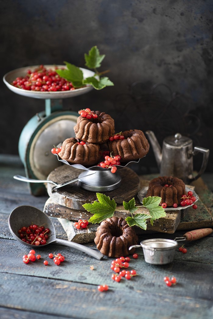 Chocolate bundt cakes with red currants on vintage scale