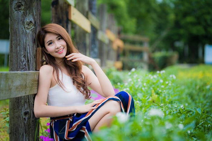 Asian Woman Smiling in Natural Greenery 4K
