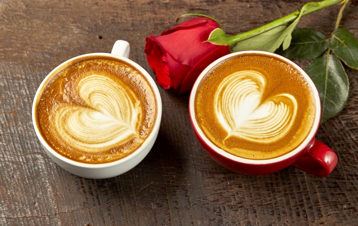 Two Cappuccinos with Heart Art and a Red Rose