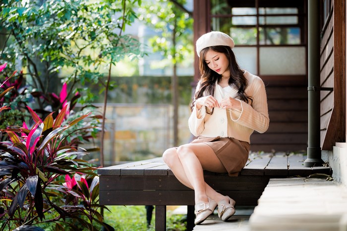4K Asian Woman Sitting Wearing Beret and Skirt
