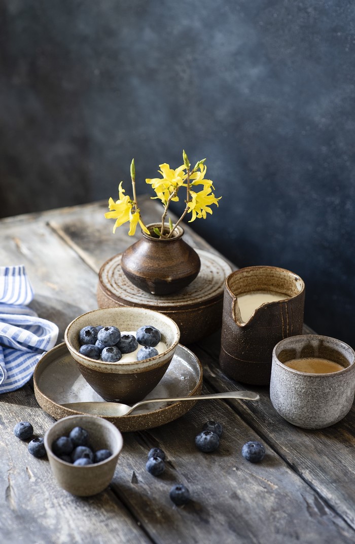 Blueberries and coffee with yellow flowers