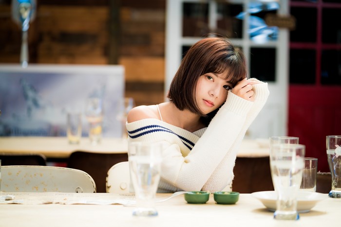 Asian woman with brown hair wearing a sweater