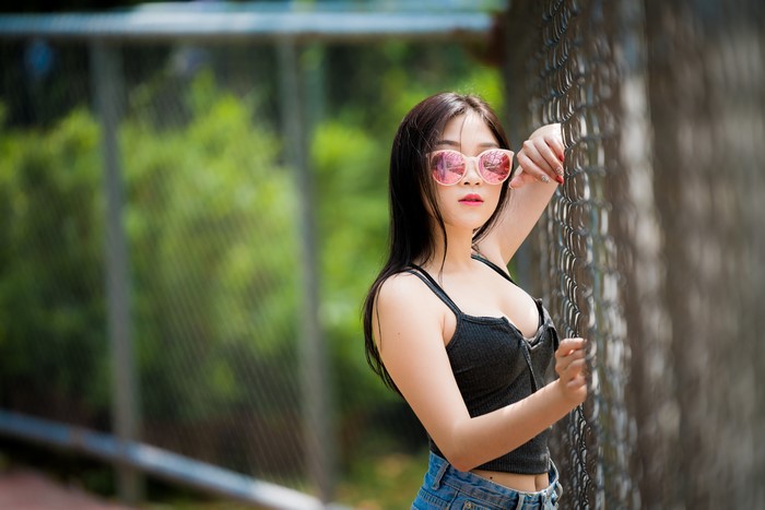 4K Asian Brunette Girl with Glasses by Fence
