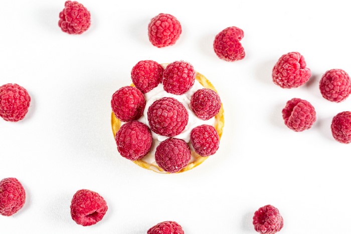 Raspberry tart with cream and raspberries