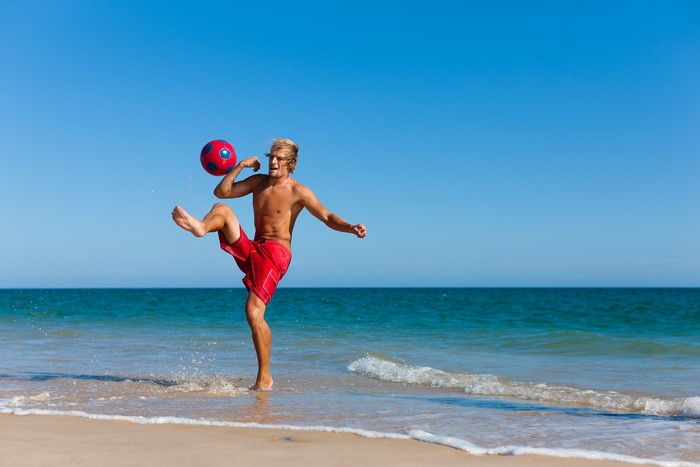 Man playing with a ball on the beach