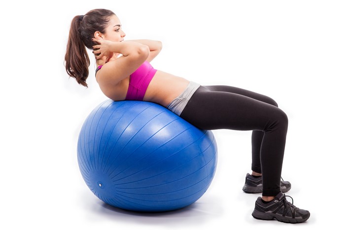 Woman doing crunches on a blue fitness ball