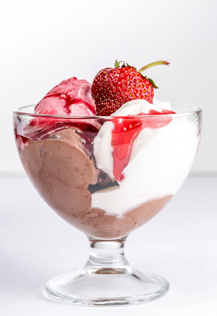 Chocolate and strawberry ice cream sundae with strawberry topping