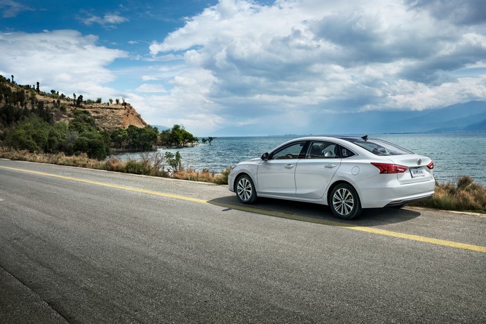 White Changan Sedan on a Coastal Road