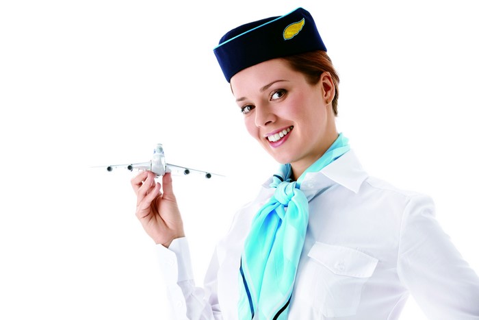 Stewardess holding airplane model