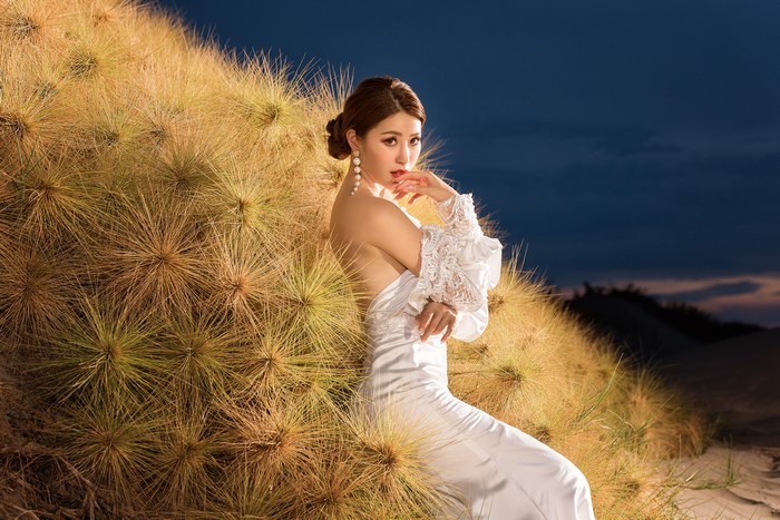 Asian Woman in White Dress Among Grass