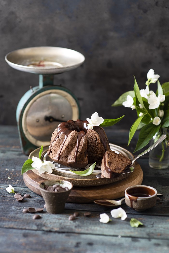 Chocolate bundt cake with chocolate glaze and jasmine flowers