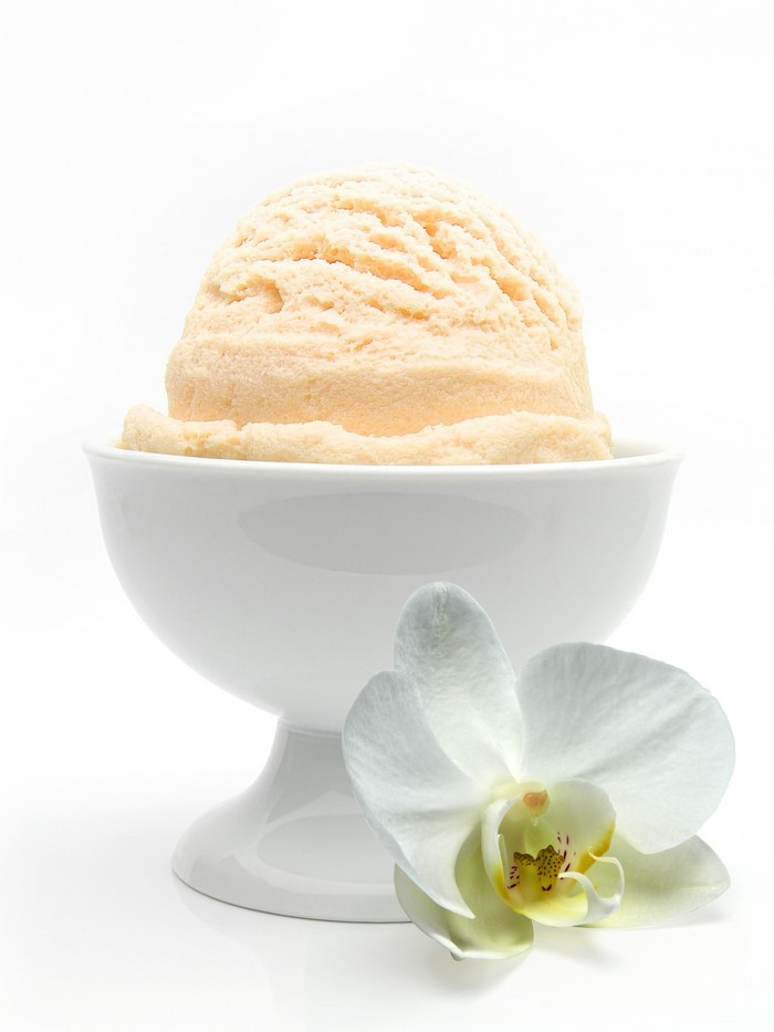 Vanilla ice cream in a bowl with an orchid