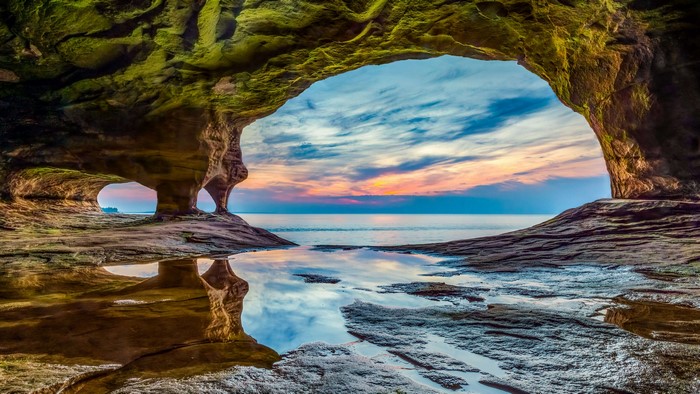Cave entrance overlooking Lake Superior at sunset