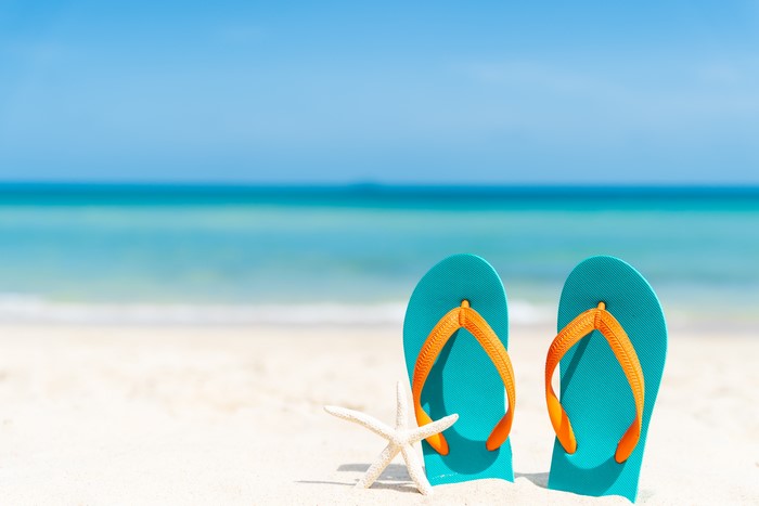 Turquoise Flip-flops and Starfish on Sandy Beach
