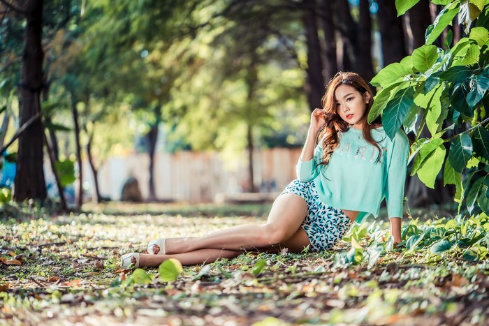 Asian woman sitting in a park