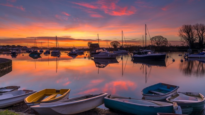 Boats on River Avon at sunrise, Dorset, England