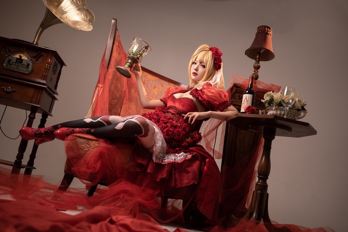 Asian woman in red dress holding a goblet