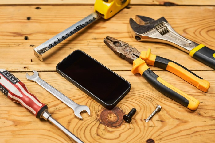 Tools and Smartphone on Wood Planks