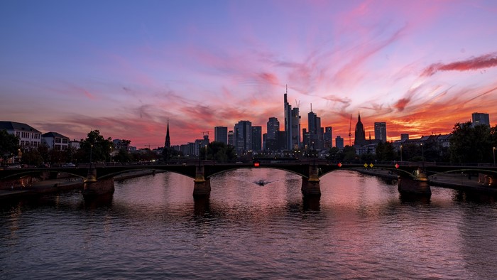Frankfurt skyline over Main river at sunset