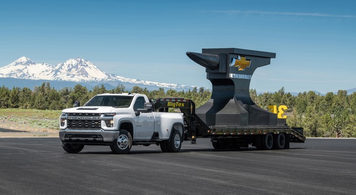 White Chevrolet Silverado 3500 HD Regular Cab towing a large anvil trailer