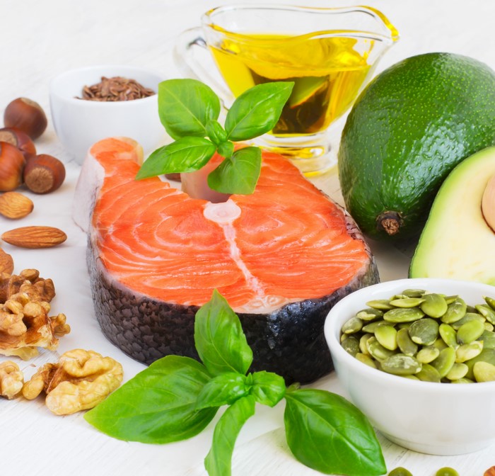 Salmon steak with avocado, nuts, and olive oil