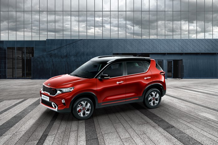 Red Kia Sonet GT-Line Crossover in front of a modern building