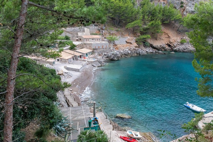 Houses on a rocky cove with turquoise water in Majorca