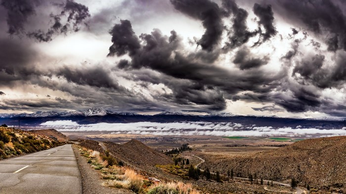 Road through Owens Valley, California under thunderclouds