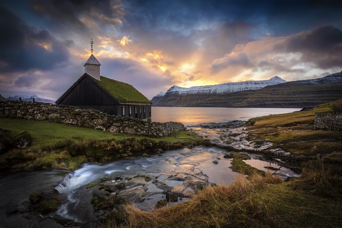 Church with grass roof in Faroe Islands at sunset