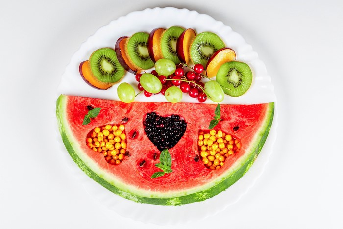 Fruit platter with watermelon, kiwi, grapes, and berries