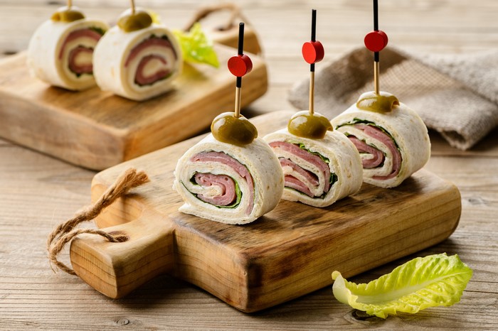 Pinwheel wraps with olives on cutting boards