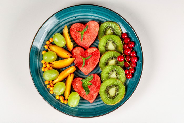 Fruit platter with watermelon hearts, kiwi, grapes, and berries