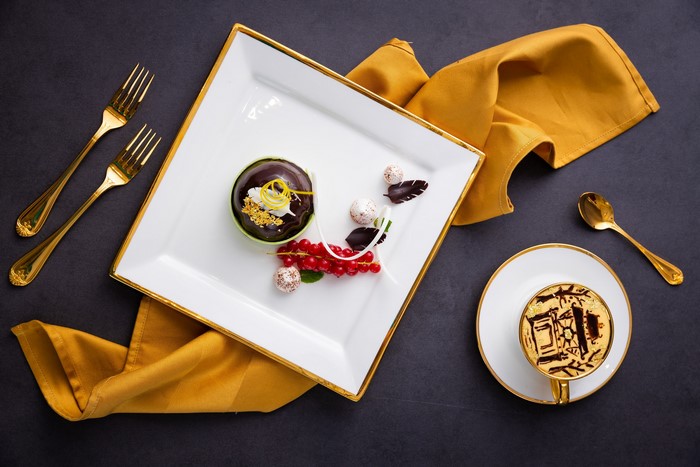 Dessert with coffee and gold cutlery
