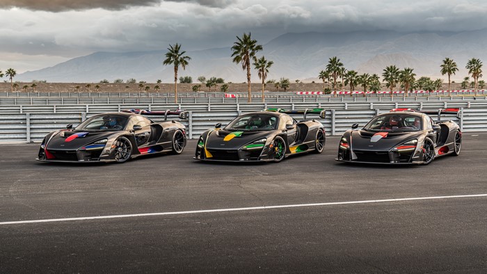 Three McLaren Senna cars on a racetrack