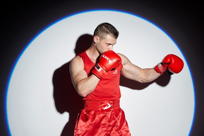 Man in boxing gear with red gloves