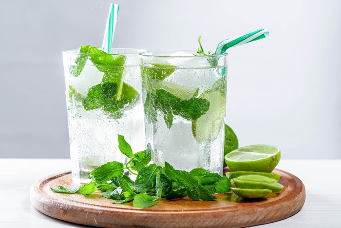 Two Mojitos with Lime and Mint on a Cutting Board