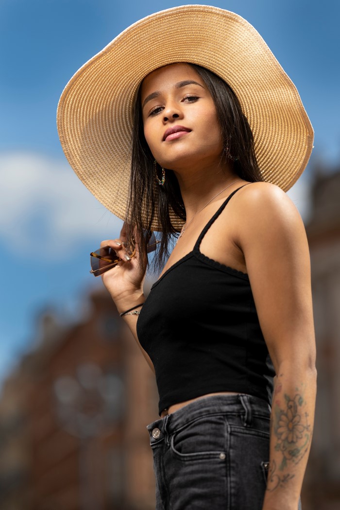 Camille wearing a hat and singlet