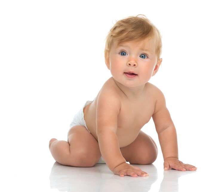 Baby boy crawling on white background