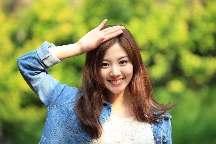 Smiling Korean Woman with Hand Gesture