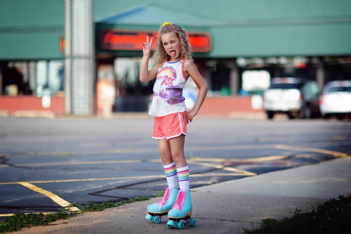 Girl in roller skates sticking tongue out